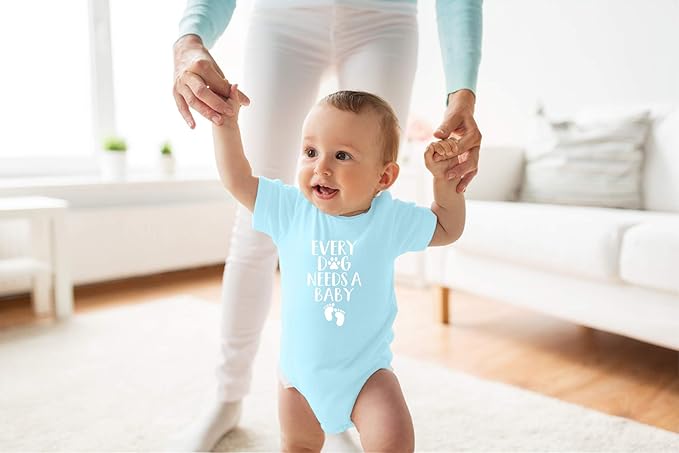 Every Dog Needs a Baby - Funny Baby Essentials Bodysuit - Baby Boy Clothes Newborn Girl Outfits