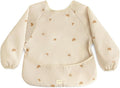 mushie Long Sleeve Baby Bib | Water Resistant Adjustable Fit for Ages 6-24 Months